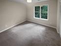 Bright bedroom with grey carpet and large window at 1097 Rock Creek Ln, Norcross, GA 30093