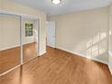 Bright bedroom with mirrored closet doors and wood flooring at 309 Quail Run, Roswell, GA 30076
