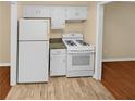 Efficient kitchen with white appliances and granite countertops at 309 Quail Run, Roswell, GA 30076