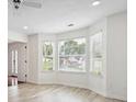 Spacious living room featuring bay windows and light hardwood floors at 1760 Waterton Ln, Lithonia, GA 30058