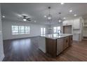 Open concept kitchen with island, stainless steel appliances, and white cabinets at 1147 Red Oak Blvd, Loganville, GA 30052