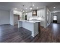 Spacious kitchen with island, stainless steel appliances, and hardwood floors at 1147 Red Oak Blvd, Loganville, GA 30052
