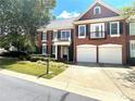 Brick two-story home with two-car garage, balcony, and landscaping at 617 Vinings Estates Se Dr, Mableton, GA 30126
