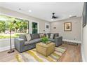 Living room with gray sectional sofa and large window at 1836 Meadow Ln, Decatur, GA 30032