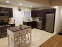 Modern kitchen with dark cabinets, granite counters, and island at 2121 Arlington Ne Ave, Atlanta, GA 30324