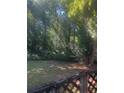 Wooded backyard with a deck and lush greenery at 4356 Housworth Dr, Stonecrest, GA 30038