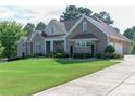 House exterior with a three-car garage and landscaped yard at 158 Watkins Glen Dr, Mcdonough, GA 30252