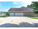 Three-car garage with a large driveway at 158 Watkins Glen Dr, Mcdonough, GA 30252