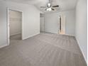 Large main bedroom with plush carpet and walk-in closet at 709 Celeste Sw Ln, Atlanta, GA 30331