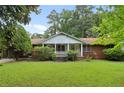Brick ranch house with a front porch and large yard at 1272 Breezy Ne Ln, Atlanta, GA 30329