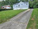 House exterior showcasing a long driveway and a well-maintained lawn at 552 Allendale Dr, Decatur, GA 30032