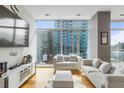 Living room with hardwood floors, city views, and comfortable sofas at 45 Ivan Allen Jr. Nw Blvd # 2501, Atlanta, GA 30308