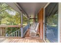 Relaxing front porch with rocking chairs and brick flooring at 1645 Highpoint Rd, Snellville, GA 30078