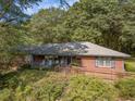 Brick ranch house with front porch and accessible ramp at 1645 Highpoint Rd, Snellville, GA 30078