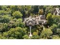 Large home nestled in lush woods with a pool and patio at 3560 Ridgewood Nw Rd, Atlanta, GA 30327