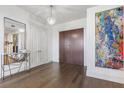 Bright and airy entryway with hardwood floors, modern console table, and large art piece at 3107 Peachtree Ne Rd # 1101, Atlanta, GA 30305