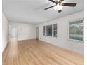 Living room with hardwood floors and large windows, offering natural light at 4440 Stonewall Tell Rd, Atlanta, GA 30349