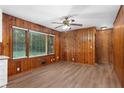 Dining area with wood paneled walls and hardwood floors at 4440 Stonewall Tell Rd, Atlanta, GA 30349