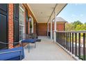 Spacious covered porch with brick flooring and comfortable seating area at 12 Ivy Chase Nw Way, Cartersville, GA 30121