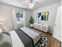 Virtually staged bedroom with stylish decor and wood-look floors at 2999 Raintree Se Dr, Conyers, GA 30094
