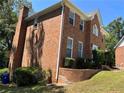 Brick home with landscaping and a side yard at 6209 Southland Forest Dr, Stone Mountain, GA 30087