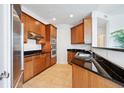 Modern kitchen features granite countertops and wood cabinets at 2828 Peachtree Nw Rd # 2002, Atlanta, GA 30305