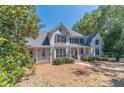 Two-story house with white siding, large windows, and porch at 990 Bramlett Shoals Rd, Lawrenceville, GA 30045