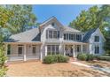Two-story house with white siding, large windows, and porch at 990 Bramlett Shoals Rd, Lawrenceville, GA 30045