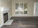 Living room with fireplace and wood-look flooring at 4538 Ravenwood Pl, Union City, GA 30291