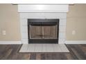 White tile fireplace with black metal screen at 4538 Ravenwood Pl, Union City, GA 30291