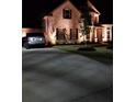 Brick home with landscaped yard and driveway, nighttime view at 6856 Louis Dr, Locust Grove, GA 30248