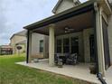 Covered patio with seating area, adjacent to the house at 6856 Louis Dr, Locust Grove, GA 30248