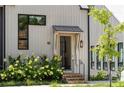 Modern farmhouse style home with gray and white exterior and landscaping at 10858 Serenbe Ln, Chattahoochee Hills, GA 30268