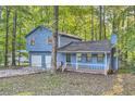 Two-story light blue house with attached two-car garage at 34 Powder Brook Ct, Dallas, GA 30157