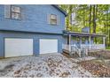 Two-story light blue house with attached two-car garage at 34 Powder Brook Ct, Dallas, GA 30157