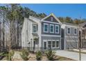 Two-story townhome with gray siding, black fence, and driveway at 5174 Longview Run, Decatur, GA 30035
