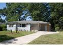 Ranch home with gray brick exterior, landscaping, and carport at 2790 Miriam Ln, Decatur, GA 30032