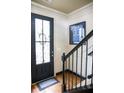 Entryway with black door and staircase at 9931 Mancunian Way, Douglasville, GA 30135