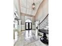 Elegant two-story entryway with tile floors and a chandelier at 404 Folsom Glade Rd, Rydal, GA 30171