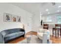 Living room with gray sofa, white chair, and hardwood floors at 741 Frederica Ne St # 23, Atlanta, GA 30306