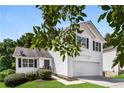 Two-story house with attached garage and front yard at 6635 Shapiro Ct, Stone Mountain, GA 30087