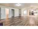 Open living room with kitchen view, hardwood floors, and neutral paint at 6635 Shapiro Ct, Stone Mountain, GA 30087