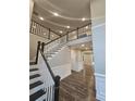 Two-story entryway with a grand staircase and dark hardwood floors at 2900 Brandford Trl, Locust Grove, GA 30248