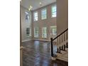 Spacious living room with high ceilings, large windows, and hardwood floors at 2900 Brandford Trl, Locust Grove, GA 30248