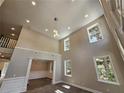 Two-story foyer with high ceilings, chandelier, and hardwood floors at 2900 Brandford Trl, Locust Grove, GA 30248