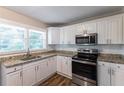 Renovated kitchen with white cabinets and granite counters at 2812 Mitchell Dr, Decatur, GA 30032