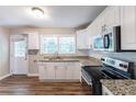 Renovated kitchen with white cabinets and granite counters at 2812 Mitchell Dr, Decatur, GA 30032