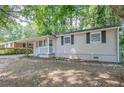 Light beige ranch house with dark gray shutters and small front yard at 416 Macedonia Se Rd, Atlanta, GA 30354
