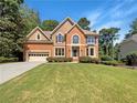 Two story brick house with attached garage and manicured lawn at 1965 Eagle Valley Ct, Lawrenceville, GA 30043