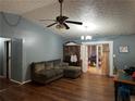 Living room with hardwood floors and built-in shelving at 577 Planters Sw Row, Lilburn, GA 30047